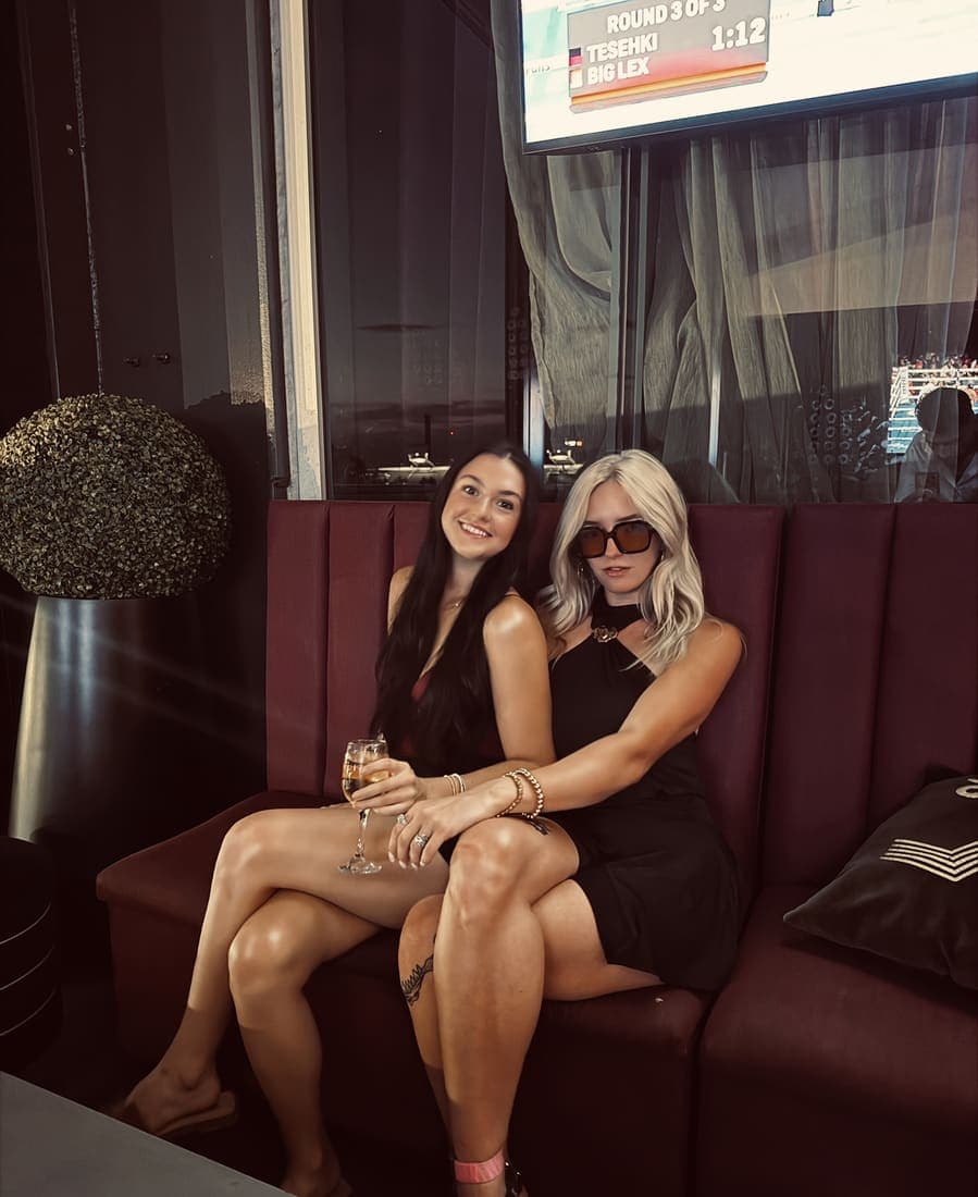 Two team members on a booth seat during a night out