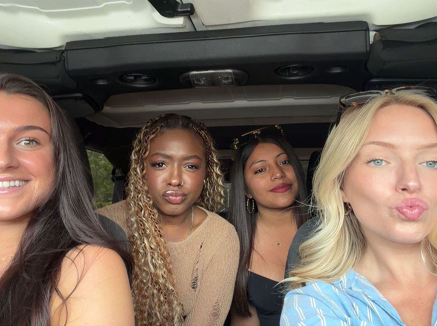 Four team members in a car on the way to the field