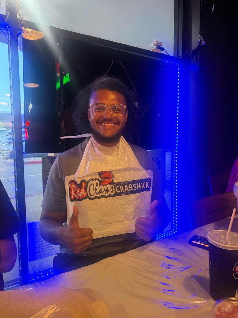 A team member at a team dinner, apron on