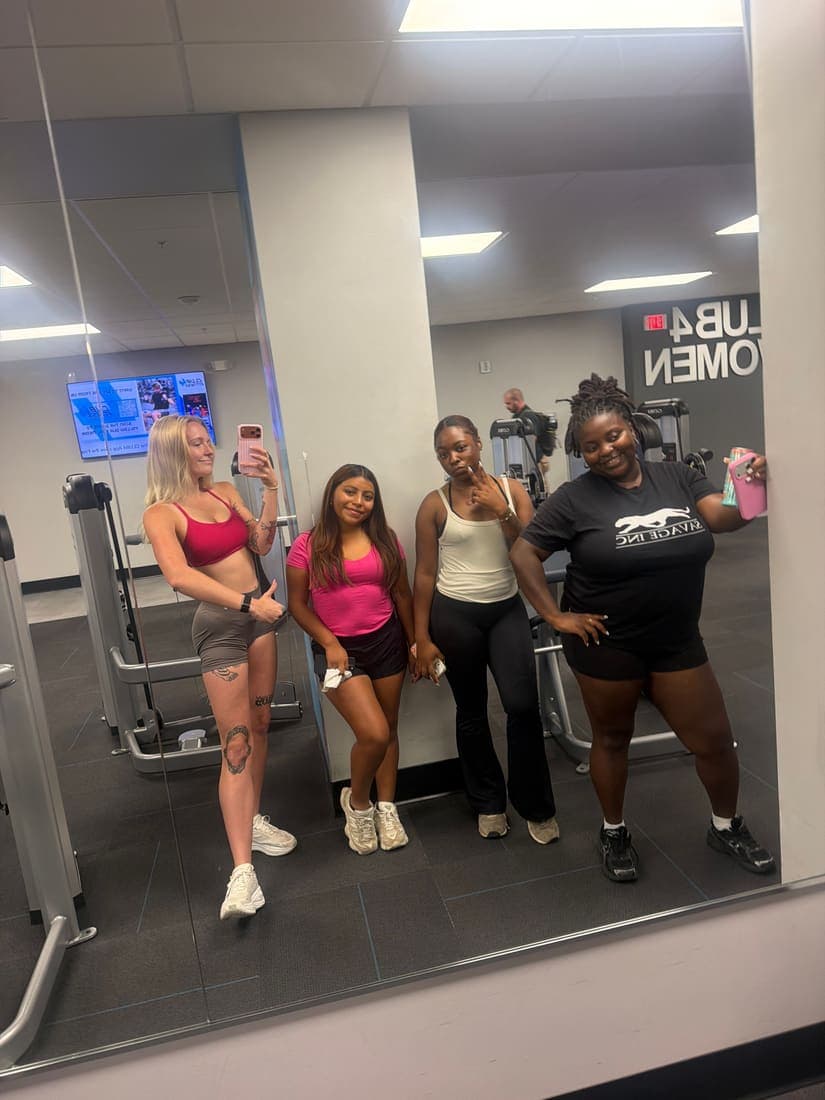 Four team members together at the gym