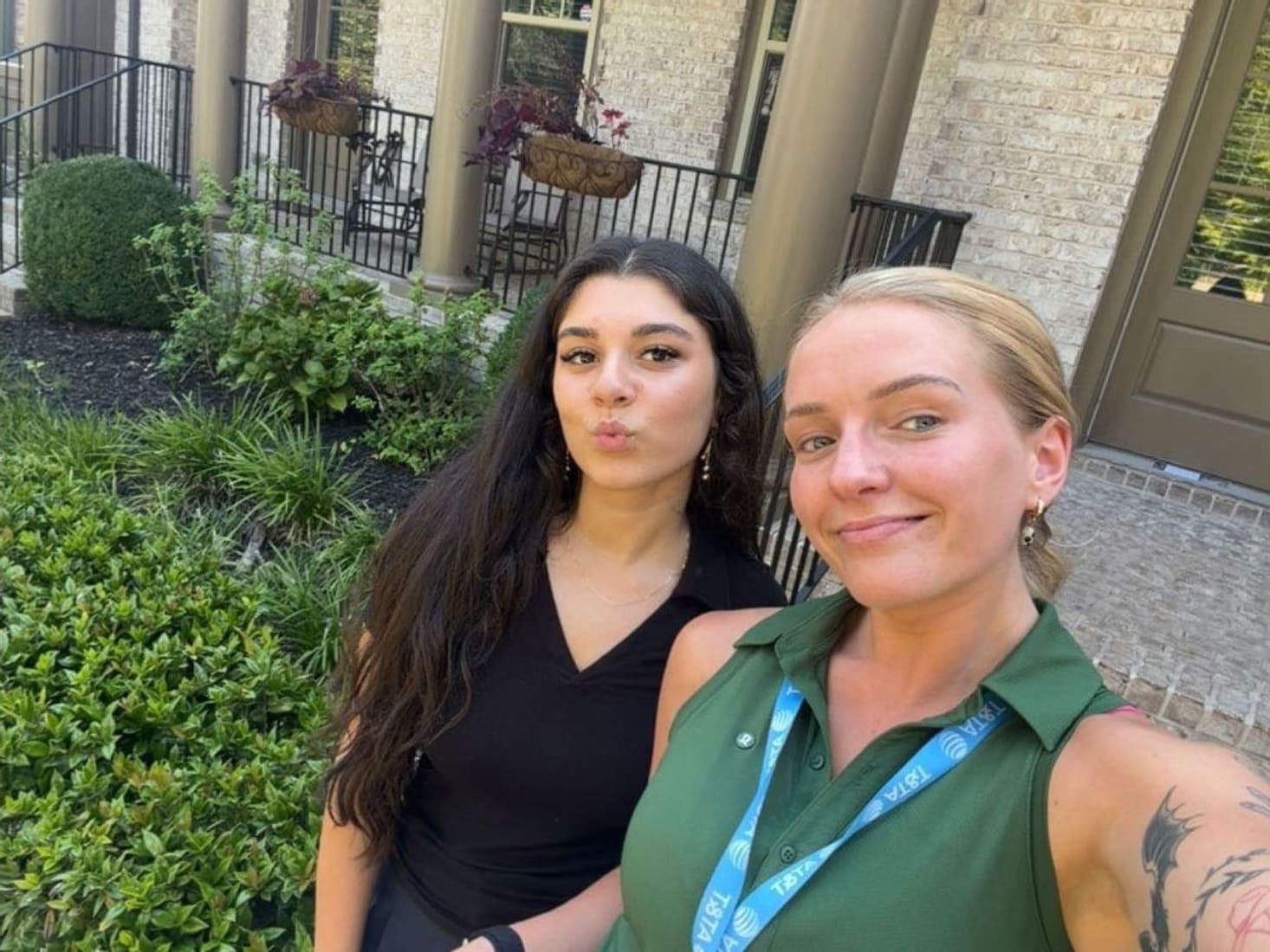Two team members outside on a patio